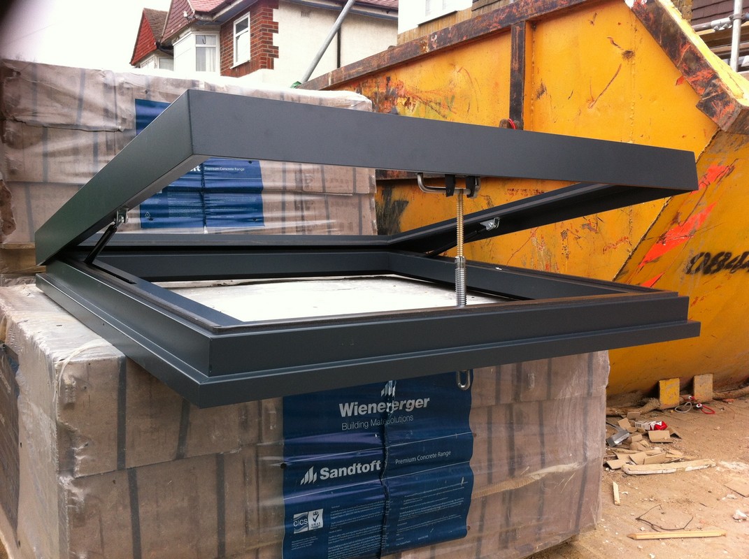 Opening flat roof skylight in anthracite grey installed in Acton